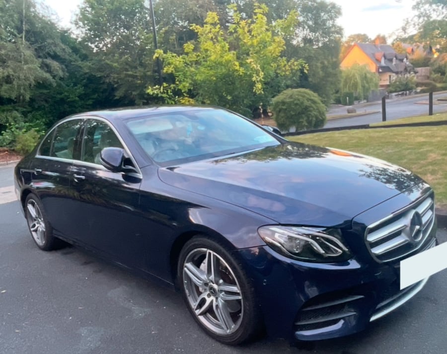 A dark blue Mercedes saloon, finished and polished on a Wicklow driveway